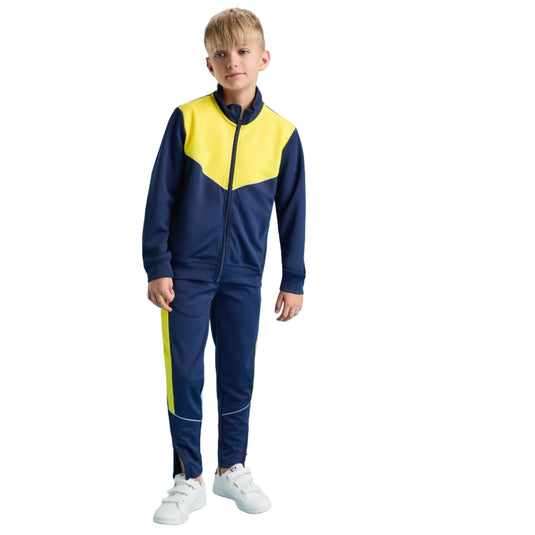 Child wearing a blue and yellow tracksuit on a blue background