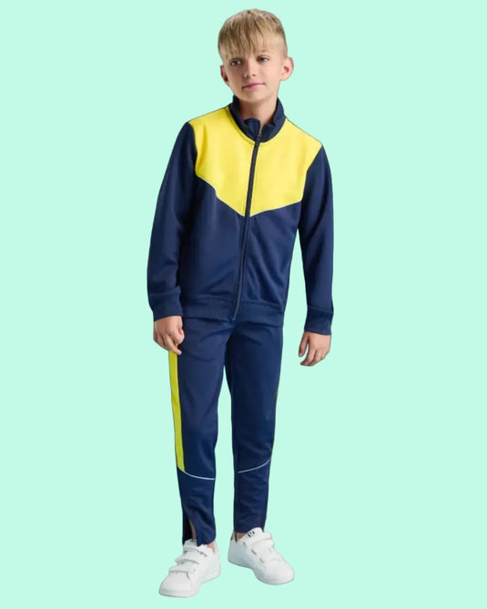 Child wearing a blue and yellow tracksuit on a blue background