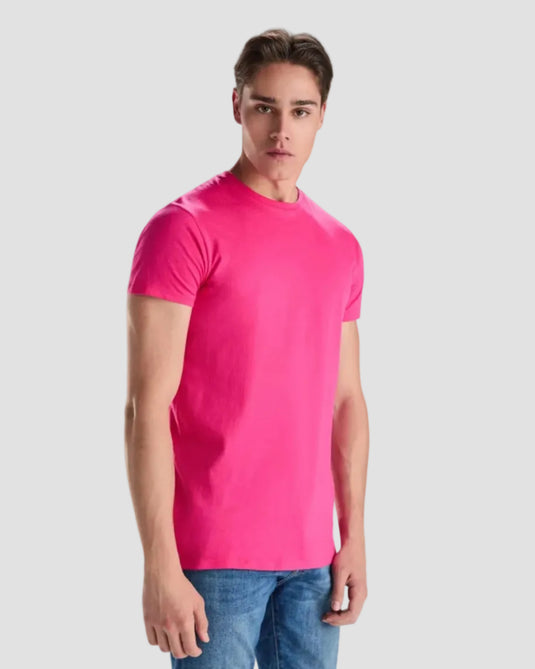 Man wearing a bright pink t-shirt on a white background