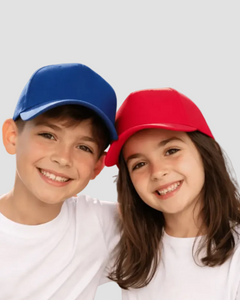 Two children wearing colorful baseball caps against a plain background