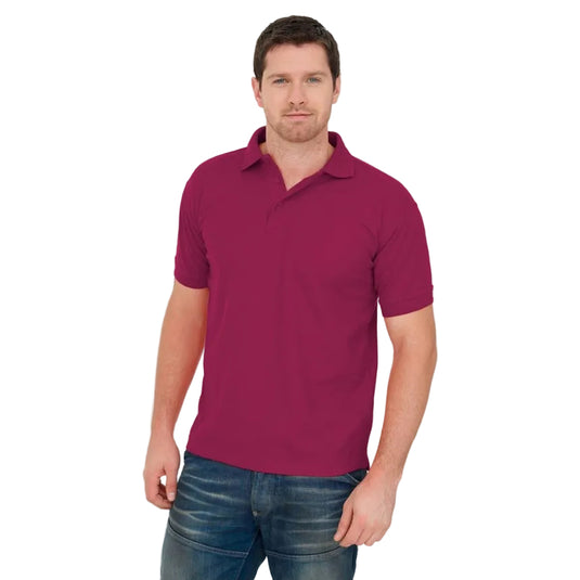 A man wearing a short-sleeve polo shirt in a deep magenta or burgundy color, paired with blue jeans, standing against a plain white background.